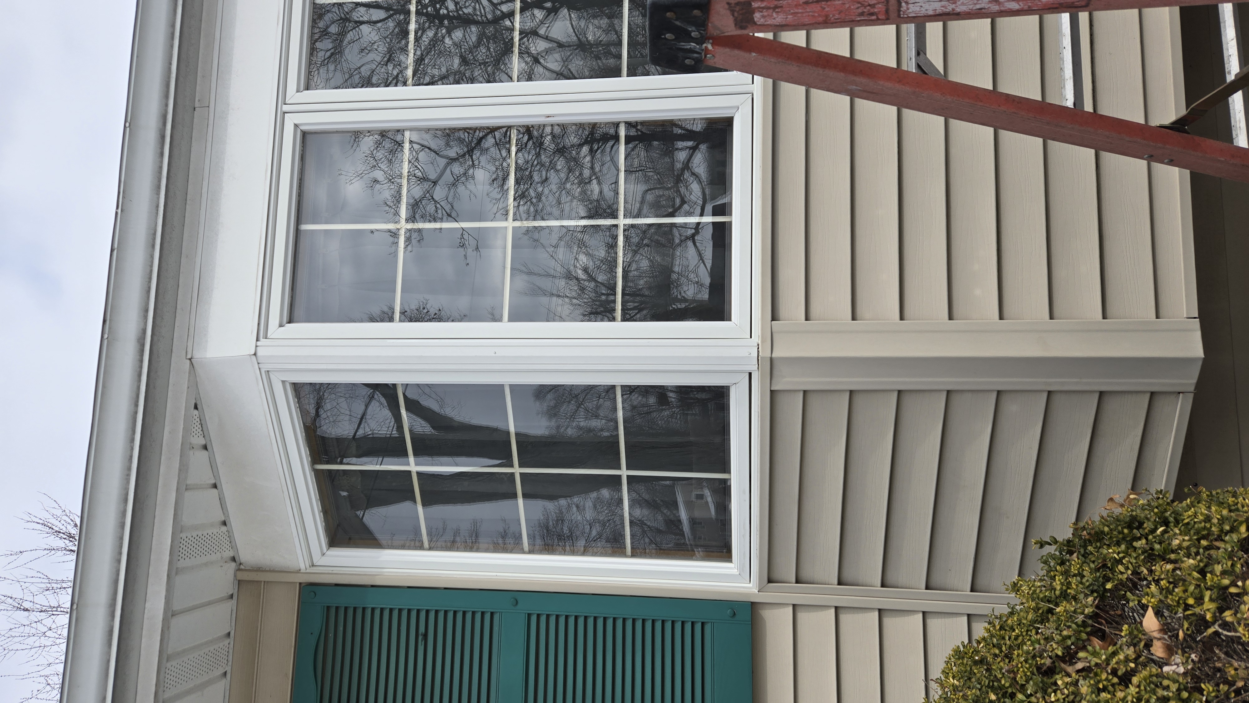 Secured and caulked exterior window trim after repair